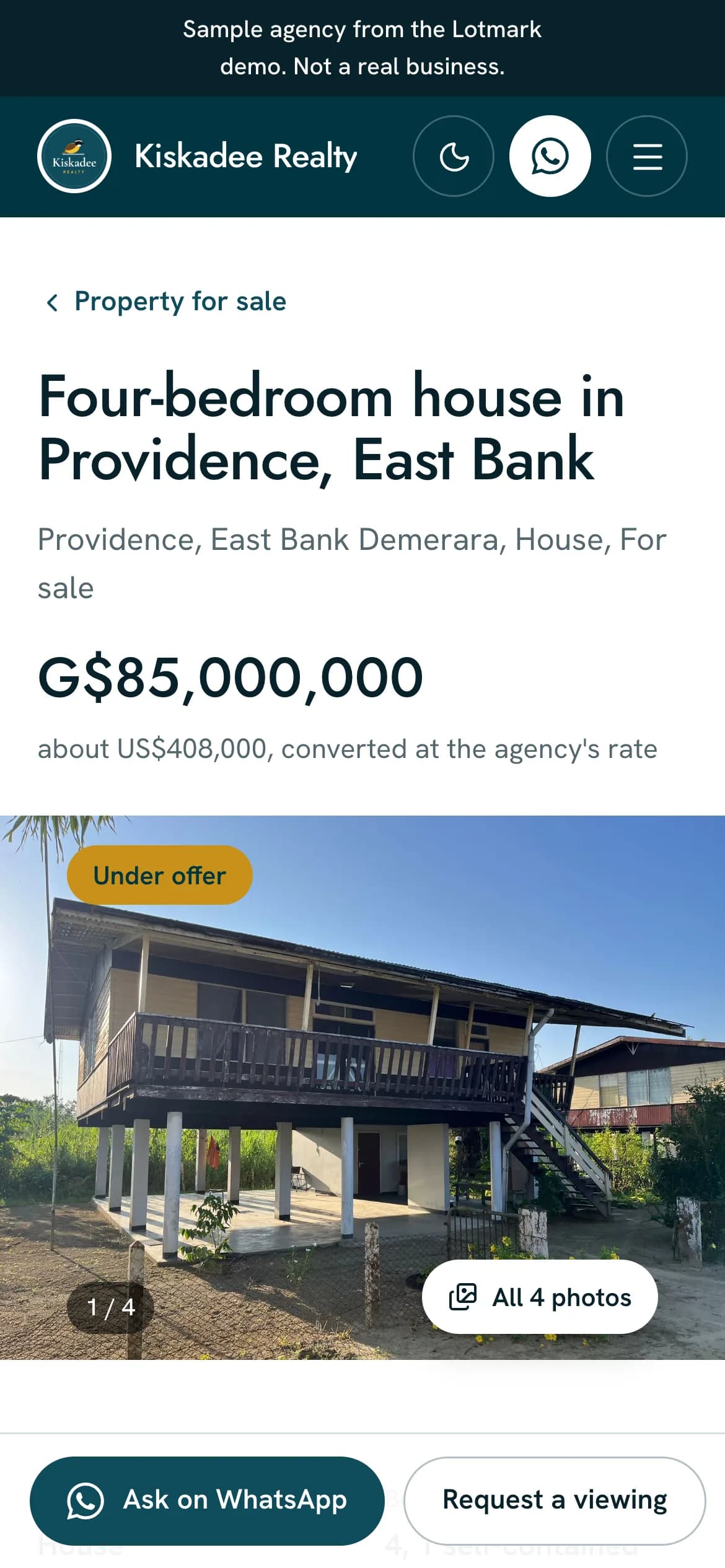 Lotmark on a phone: the demo agency's own website, showing a four-bedroom house in Providence, East Bank, for sale at G$85,000,000, about US$408,000 at the agency's rate, above the first of its four photos, marked under offer.
